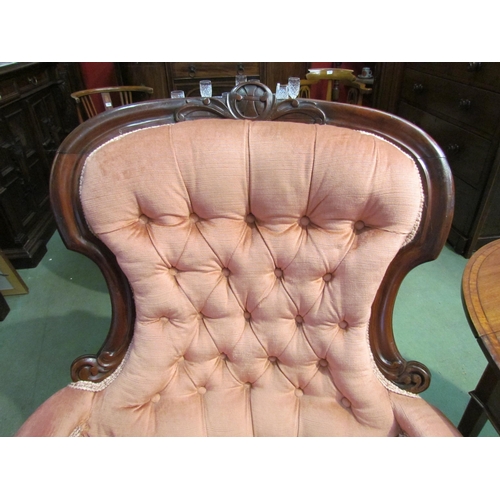 4074 - Circa 1850 a carved mahogany button back rest salmon pink upholstery library armchair, the scroll ca... 