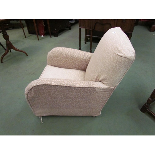 4110 - A Circa 1920 rounded armchair on castors with removable loose cover    (R) £60