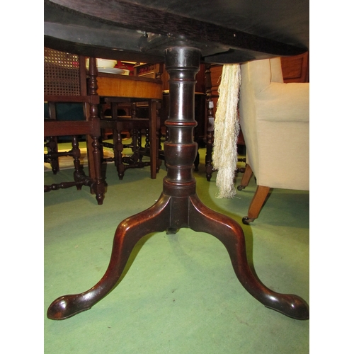 4172 - A George III flame mahogany circular tilt top wine table on a turned column and tripod base with ori... 