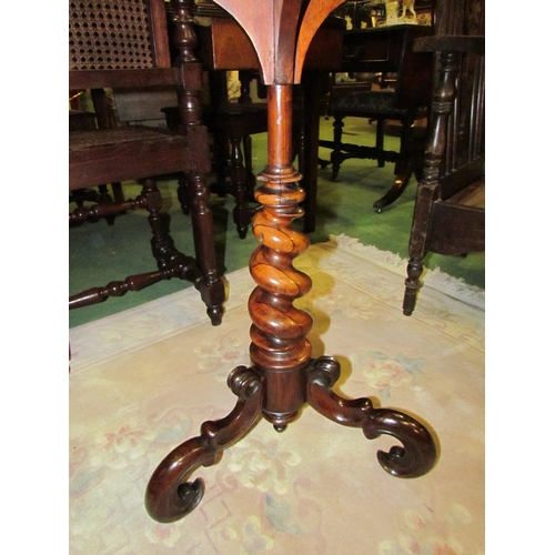 4186 - An early Victorian rosewood and mahogany circular dished top wine table on a tapering spiral/turned ... 