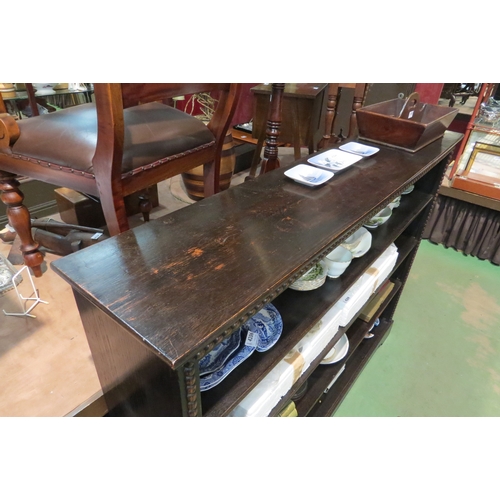 4216 - A Circa 1920 oak bookshelf in the Jacobean style with half bobbin turned moulded decoration on a bra... 