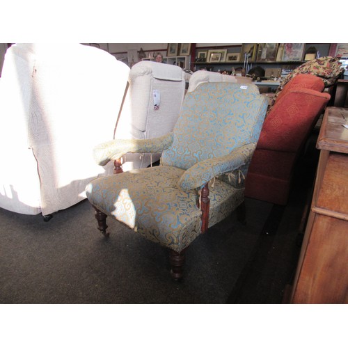 1178 - A Victorian deep-seated armchair with scrolled foliate pattern upholstery, on turned legs, for re-up... 