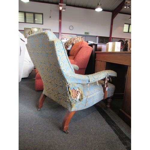 1178 - A Victorian deep-seated armchair with scrolled foliate pattern upholstery, on turned legs, for re-up... 