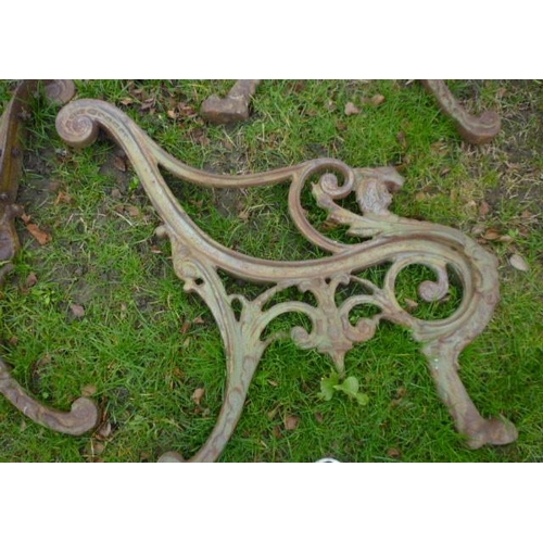 5043 - A heavy cast iron ended garden chair and two sets of matching ends