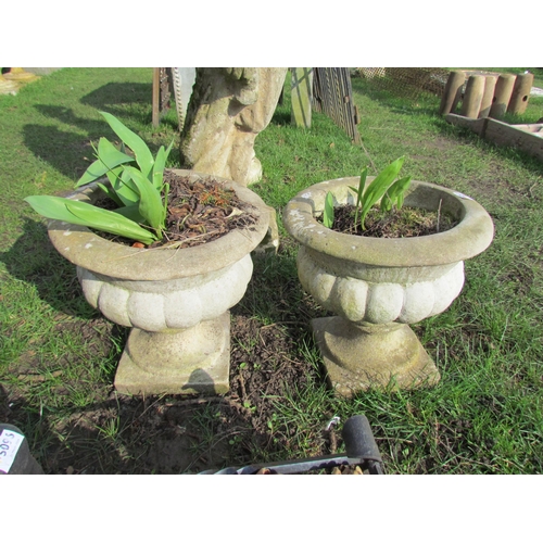 5097 - A pair of garden urns on socle bases