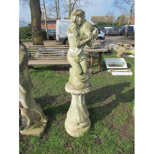 5099 - A garden figure of semi-clad female with conch shell, raised on a wrythen plinth, approximately 53