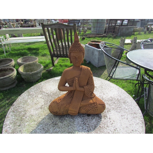 5110 - A seated rust effect figure of a deity, 15