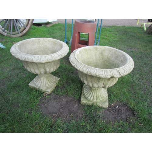 5120 - A pair of composition urns on socles, 18