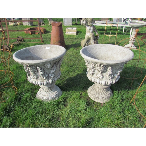 5254 - A pair of decorative composition urns on socles, 22