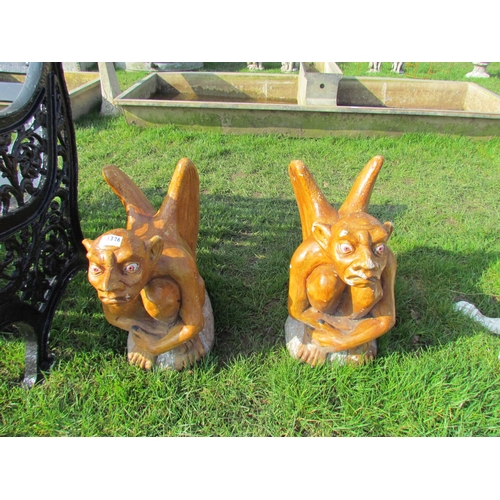 5326 - A pair of glazed and painted gargoyle gate post finials, 18