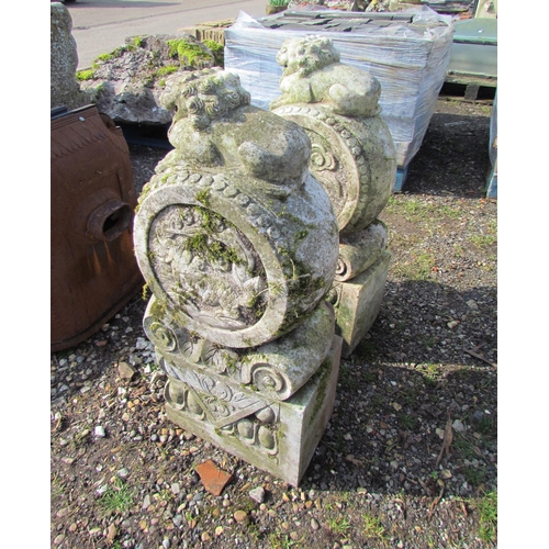 5370 - A pair of decorative Chinese marble garden features, dogs on Fo on round panels on plinths, 35