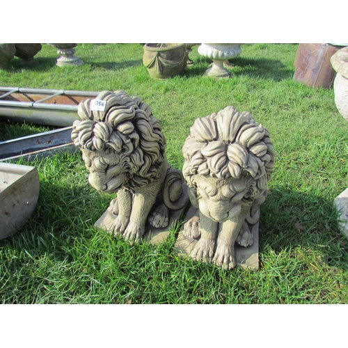 5396 - A pair of glazed composition seated lions, 16