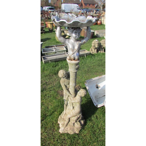 5421 - A composition figural group holding a loft a cast iron birdbath, 44