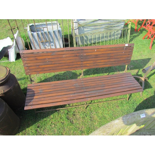 5438 - A wrought iron framed wooden slatted garden bench, 59