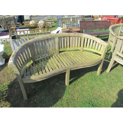 5447 - A curved hardwood garden bench, 63