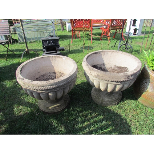 5451 - A pair of reconstituted semi-gadrooned urns on socle bases, 19