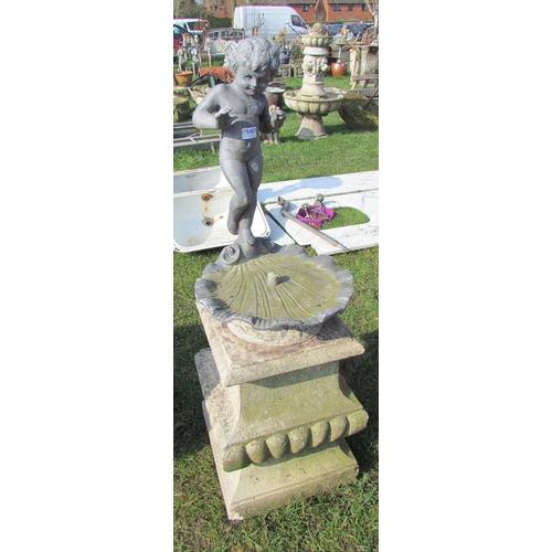 5457 - A lead shell form birdbath, surmounted by cherub on shaped stone plinth, lead feature is 24