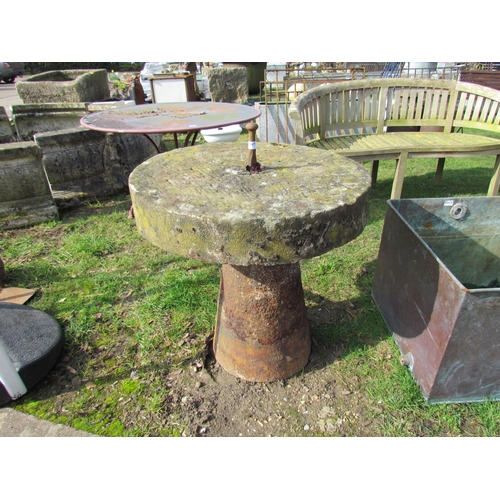 5477 - A cast iron staddle base with round grinding stone top, 30