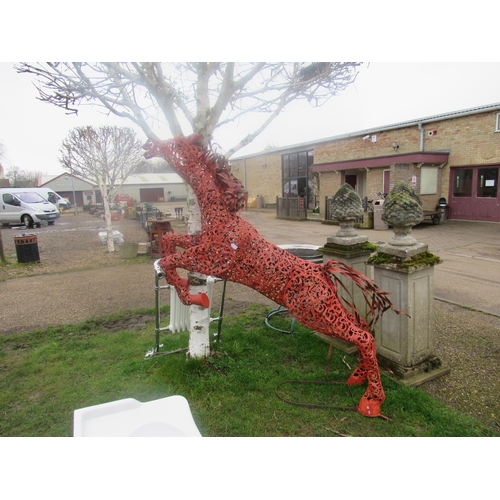 5466 - A decorative red painted, pierced metal study of a leaping horse  (R)  £300