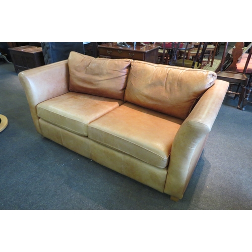 1142 - A modern tan leather two seater sofa