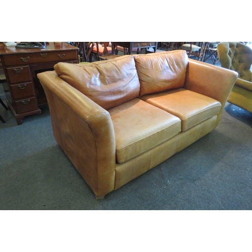 1142 - A modern tan leather two seater sofa