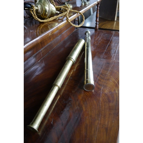 1185 - A brass two draw telescope with named Gieves Ltd cap and a similar three draw example (2)   (R) £30