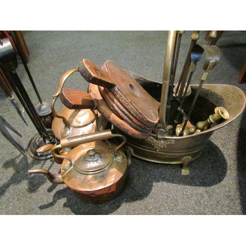 1062 - Two copper kettles (dented), a pair of bellows, pair of brass candlesticks, fireside tools and a bra... 