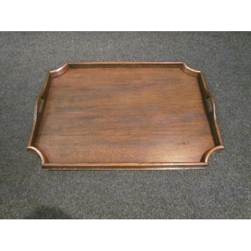 1077 - A hardwood twin handled tray with copper corners, 56cm long