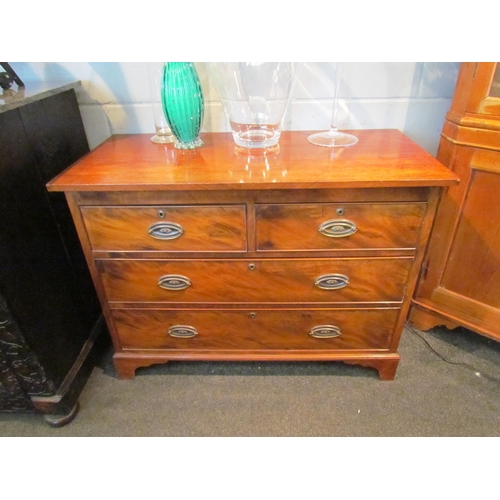 1083 - A 19th Century mahogany chest of two short over two long drawers, oval brass plate handles, on brack... 