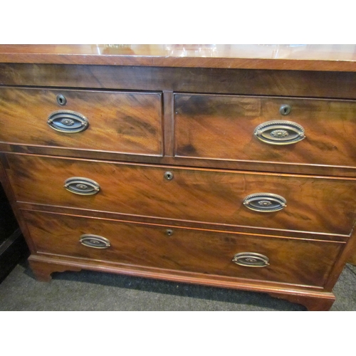 1083 - A 19th Century mahogany chest of two short over two long drawers, oval brass plate handles, on brack... 