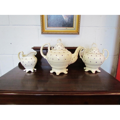 1091 - A Victorian teapot, milk jug and sugar bowl with lid, cream ground with blue and gilt spots