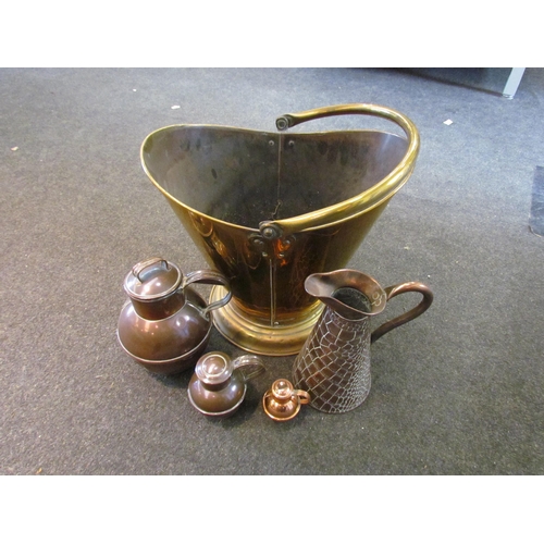 1095 - A brass coal scuttle together with a copper scaled effect jug and three copper lidded jugs of variou... 