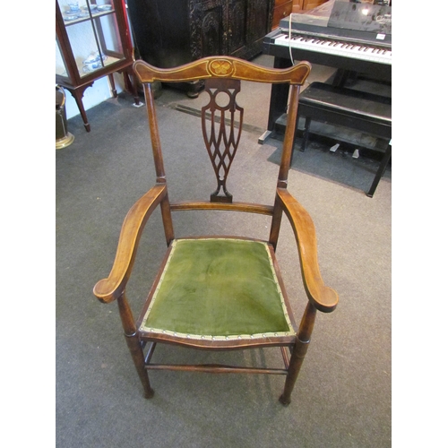 1105 - An Edwardian walnut elbow chair with pierced back splat (a/f), butterfly marquetry detail, green vel... 