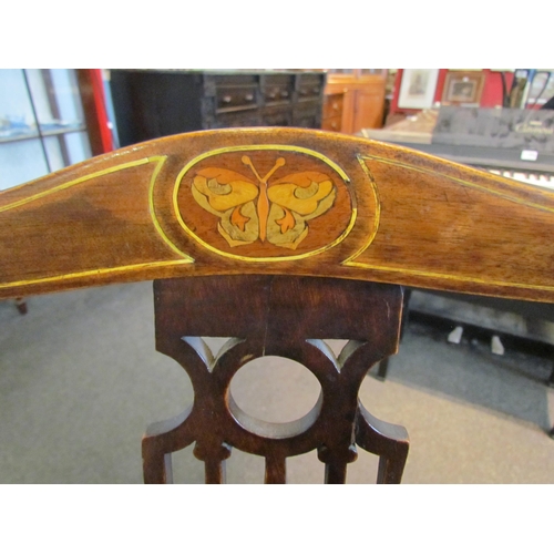 1105 - An Edwardian walnut elbow chair with pierced back splat (a/f), butterfly marquetry detail, green vel... 