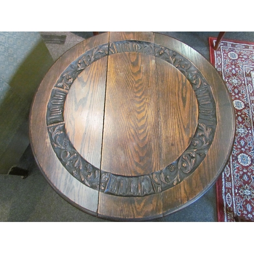 1111 - A carved oak drop-leaf occasional table on bobbin turned supports