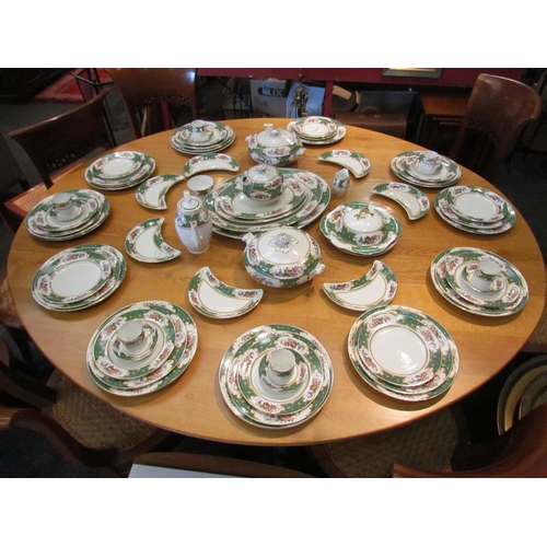 1112 - A Bridgwood dinner and coffee service retailed by Waring & Gillows, green and floral border, some pi... 