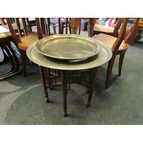 1115 - An Eastern brass table on wooden base and a circular brass tray a/f