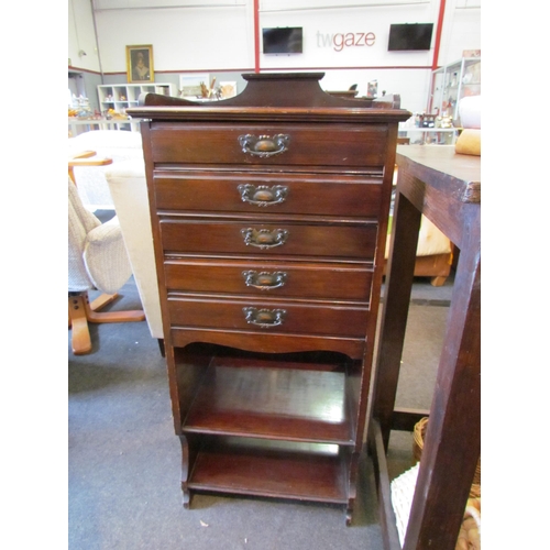 1132 - An Edwardian walnut music cabinet, the five drawers over open shelves, 110cm tall x 50cm wide x 36cm... 