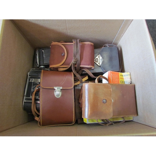 1152 - A box containing folding cameras