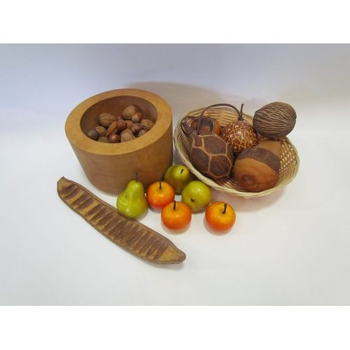 1170 - An ash turned bowl containing nuts and wooden fruit, together with a basket containing seed pods, et... 