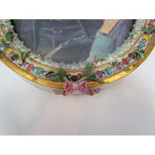 1178 - A pair of floral encrusted porcelain picture frames surmounted by cherubs, crossed sword marks to to... 