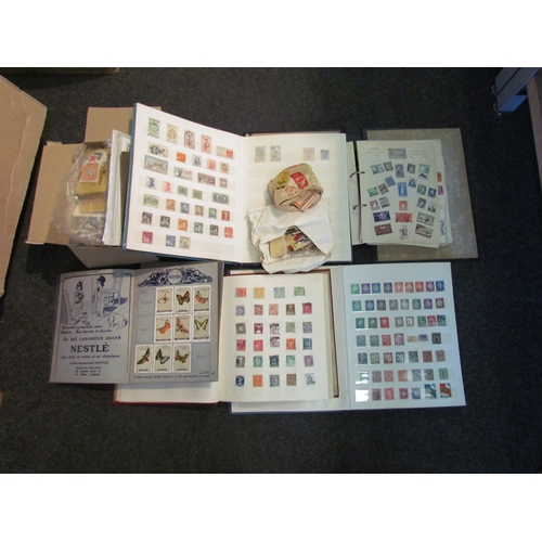 1215 - A box containing stamp albums with worldwide content, matchbox covers and Nestle cards    (E) £15-25