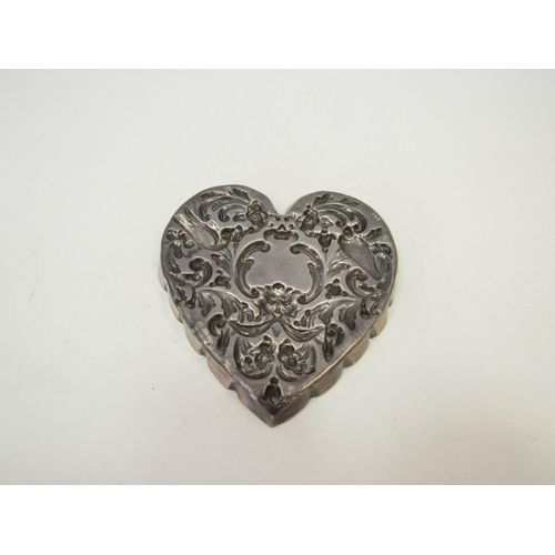 1306 - A William Comyns silver heart shaped pin dish with embossed floral, bird and mask design.  London 18... 