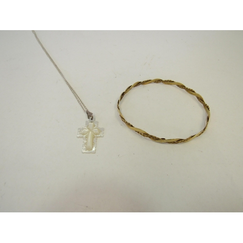 1313 - A yellow metal bangle stamped 9K together with mother of pearl crucifix pendant on silver  necklace ... 