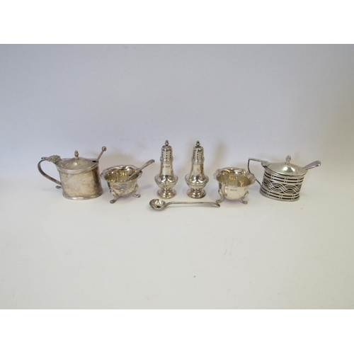 1342 - A pair of silver pepperettes, two silver mustard pots and two silver salts, various matched spoons