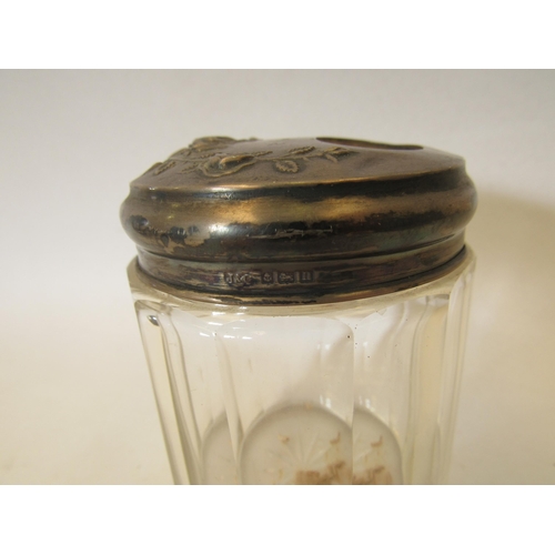 1366 - A pair of silver lidded glass jars with embossed floral design.  Birmingham 1912