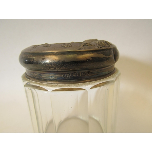 1366 - A pair of silver lidded glass jars with embossed floral design.  Birmingham 1912