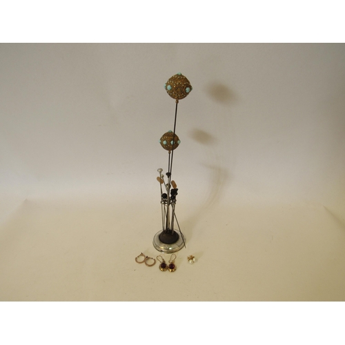 1369 - A silver hat pin stand together with various hat pins and three pairs of earrings