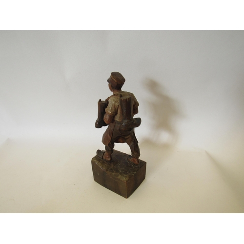 1382 - A carved wood figure of a man with a pair of boots hung over his shoulder 23cm tall and a small Blac... 