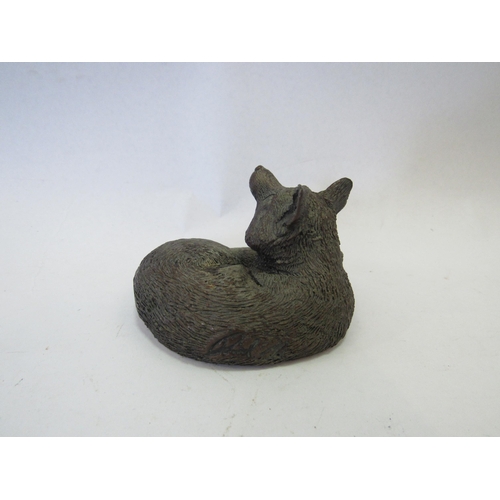 1243 - A bronze sculpture of a Fox, signed to back, 5cm tall